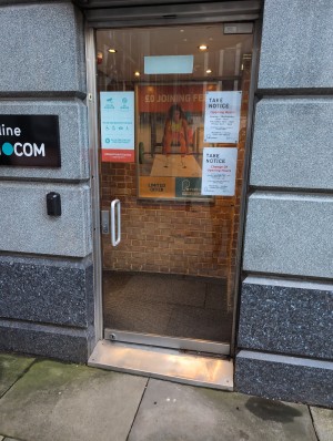 Glass door need to push to open, small step at the entrance