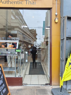 Entrance door looking straight. Glass door. Push on the left to open.