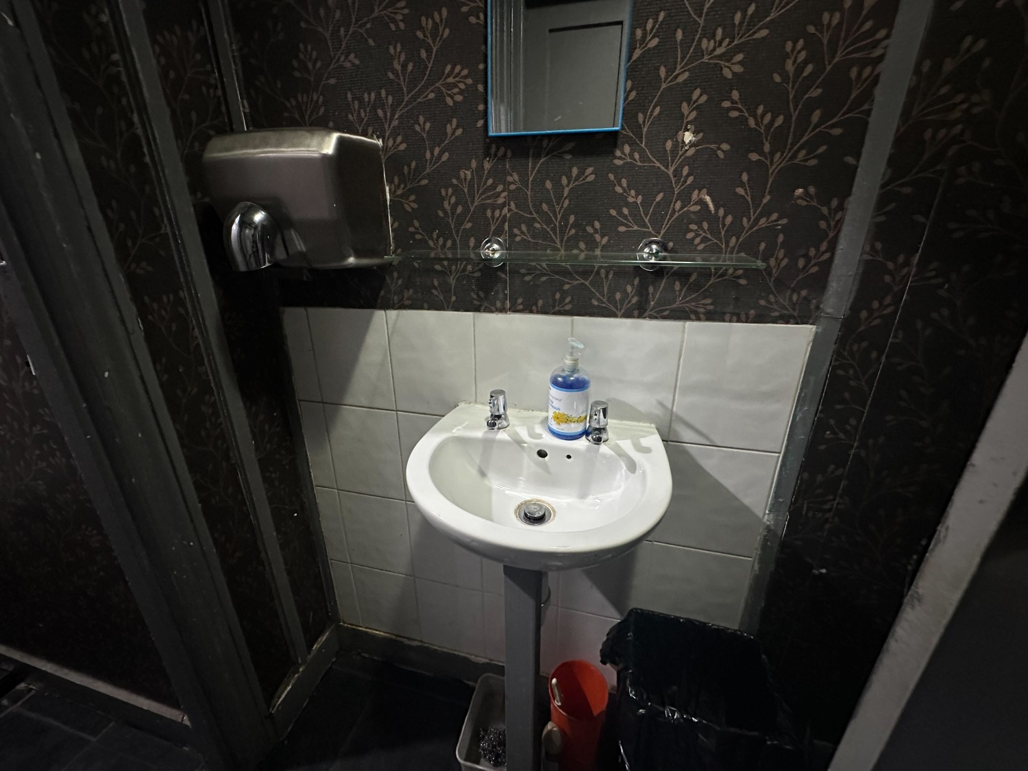 From door facing right. Sink on back wall.