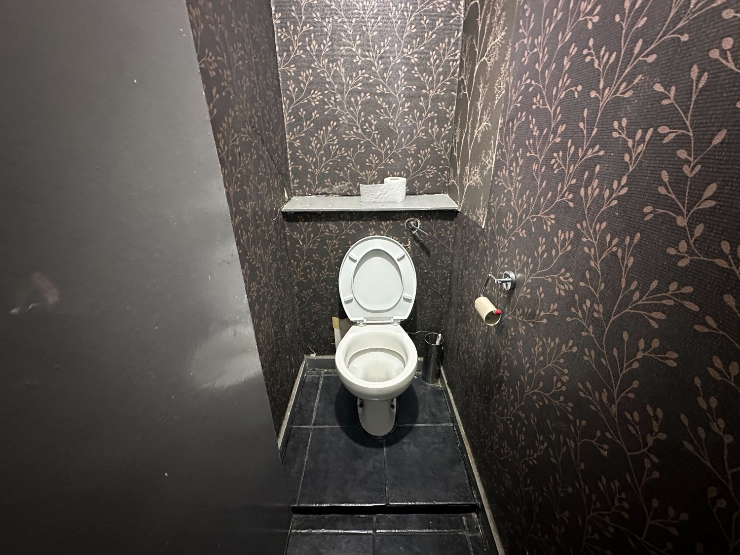 From cubicle door looking straight. Toilet on back wall.