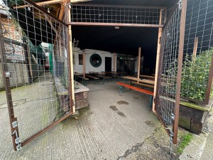 Gate-style doors to outdoor front seating area and main entrance. Pull towards centre to open.