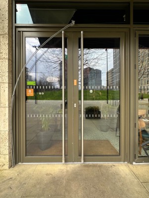 Bronze framed glass doors. Pull silver handles in centre to open.
