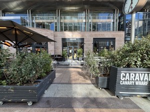 From pavement facing venue. Planters on left and right. Path in centre to entrance at the back.