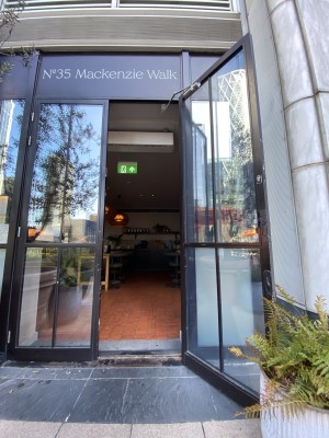 Glass doors with black frame ahead. Pull from centre to open.