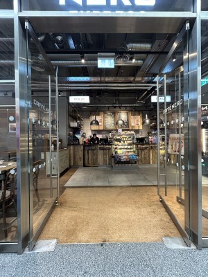 Glass doors ahead with silver handles in centre. Push to open.