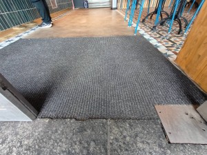 Bump on threshold of double glass doors. Carpeted flooring ahead of bump.