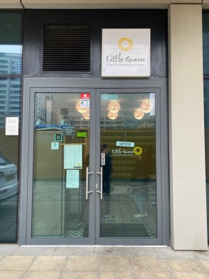 Glass doors with grey frames and silver handles. Push from centre to open.