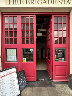 Red framed glass doors. Push from centre to open.