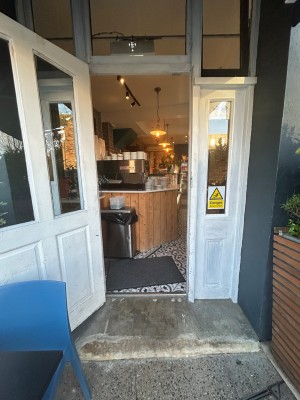 White wooden single door with glass panels. Pull from left to open.