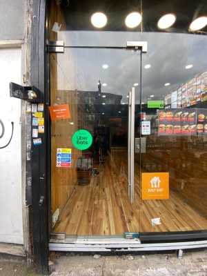 Glass door, handle on right. Push to open.