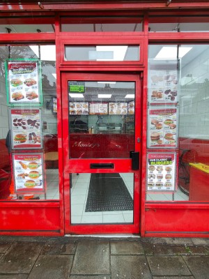Red framed door. Push black handle on right to open.