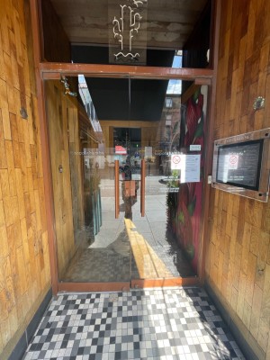Glass double door with handle in centre, pull to open.