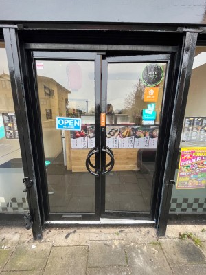 Black framed doors, push from handles in centre to open.