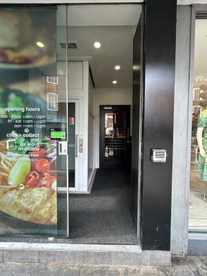 Sliding single glass door. Slide from right to open. Doorbell to right of door.