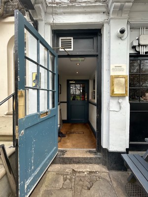 Single preceding blue wooden door with glass panels. Pull from right to open.