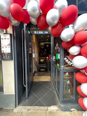 Dark grey open archway precedes main doorway.