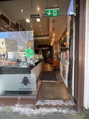 Single glass door with silver metal handle. Push from left to open.