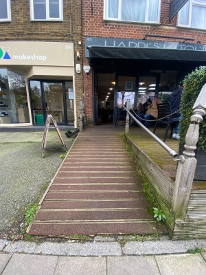 From street, looking at venue. Built-in ramp ahead, than landing. Handrail on right.