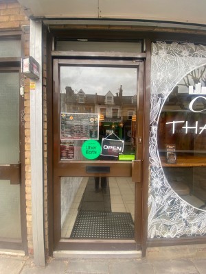 Glass door, with brown doorframe. Handle on right. Pull up open.