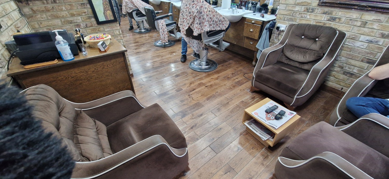 Photo of waiting area with wide sofa chairs and low coffee table.