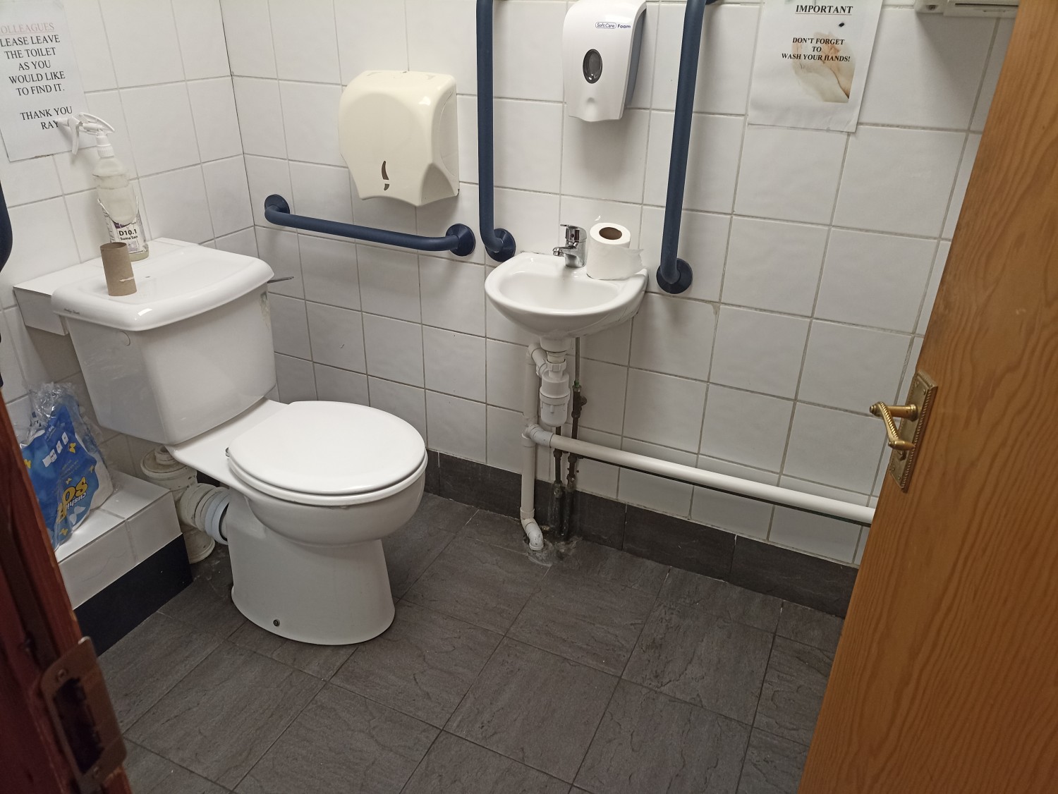 Spacious disabled-friendly bathroom with railings.