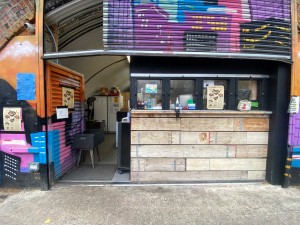 From path, facing venue. Counter at back right.