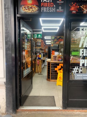 Glass door with black frame ahead. Push from right to open.
