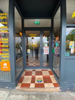Glass door, with grey doorframe. Handle on right. Pull to open.