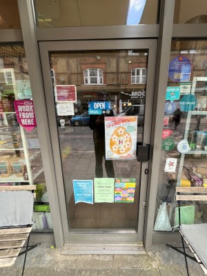 Grey framed glass door. Push from right side to open.