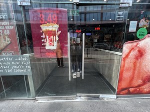 Glass doors. Push silver handles in centre to open.