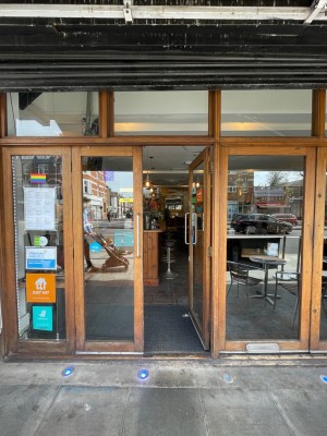 Wooden glass double doors with handle in centre, push to open.