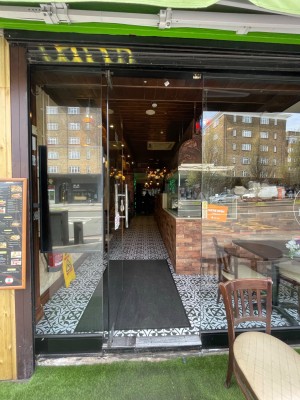 Glass door with handle at right, push to open.