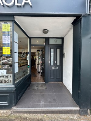 Green archway in front. Second door at back.