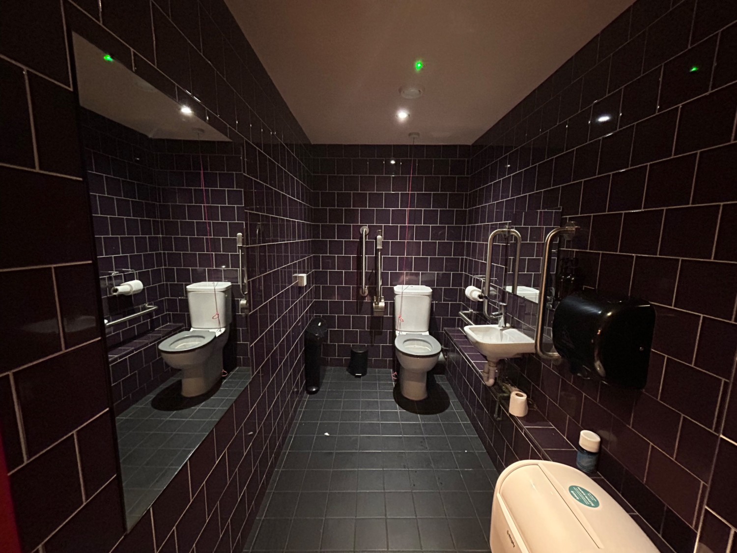From doorway, facing left. Sink in middle of right wall. Toilet on right of back wall. Pull cord to left of toilet.