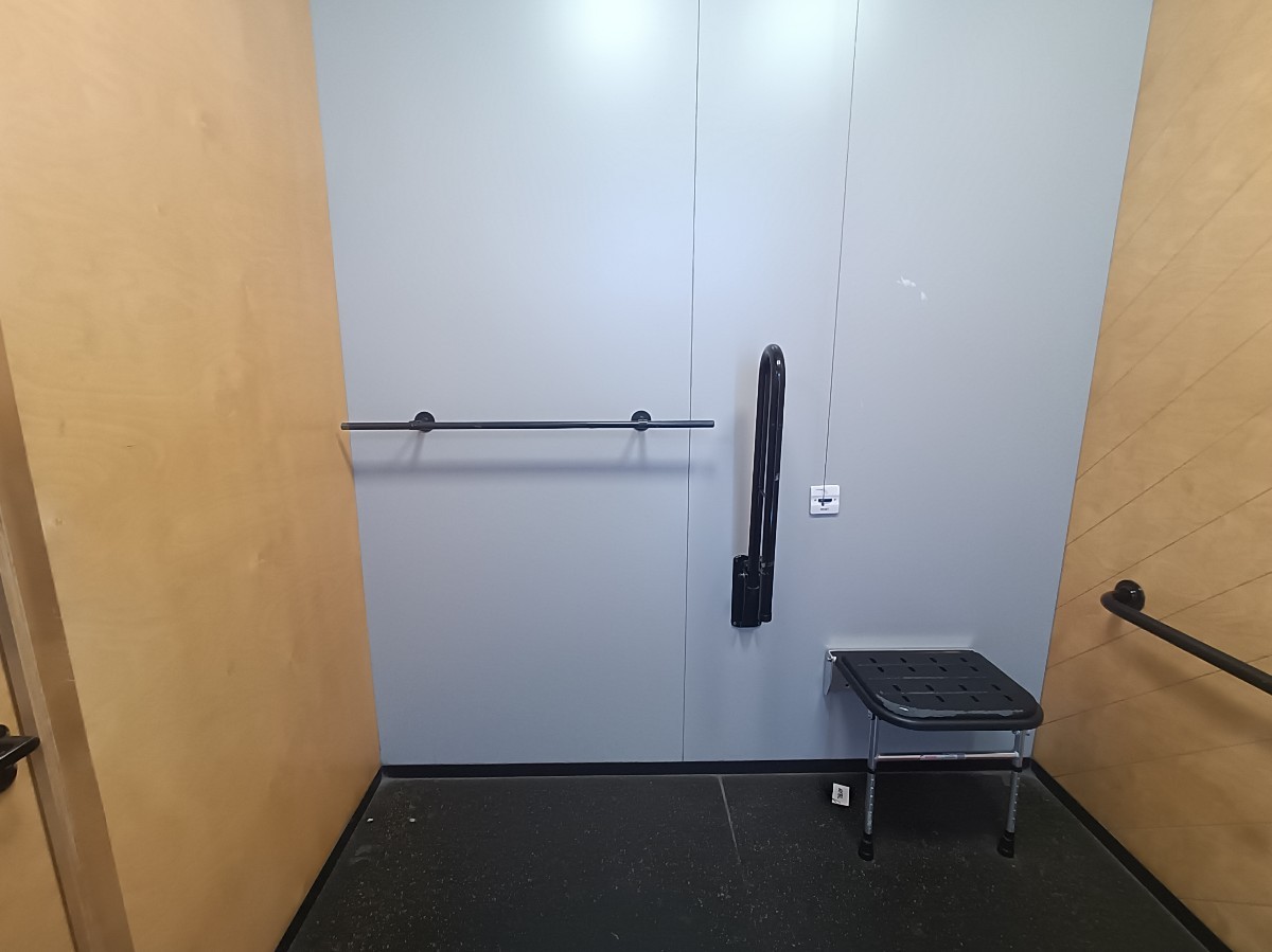 From doorway, looking left. Stool at back right. Emergency pull cord to its left.