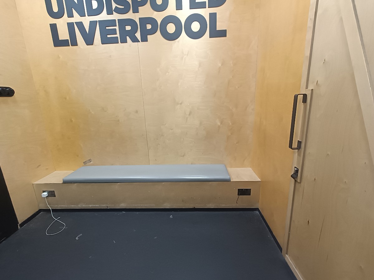 From after staff desk, looking left. Bench along back. Accessible fitting room on right.