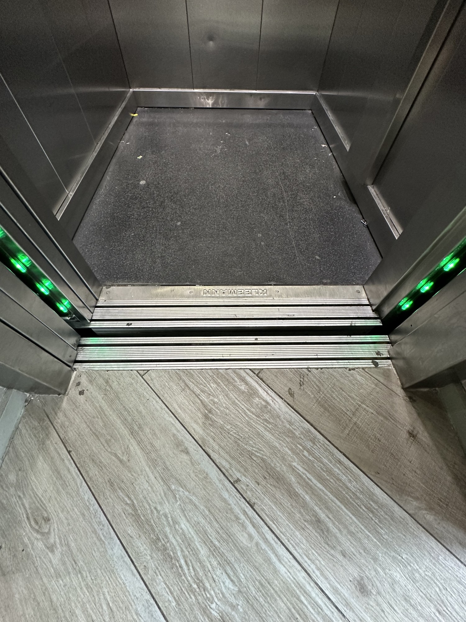 Gap and bump at threshold of lift doors.
