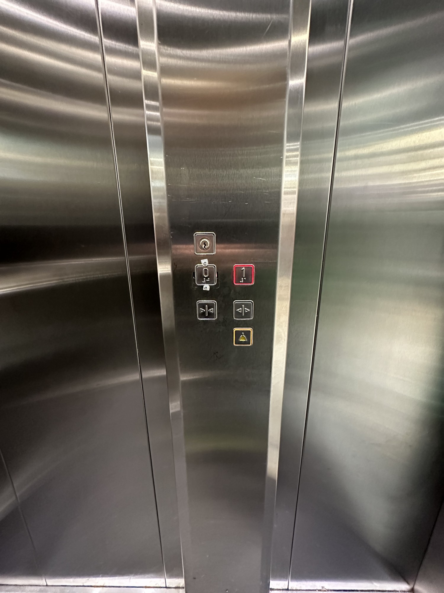 Lift panel on right with textured buttons including braille.