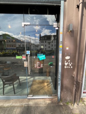 Glass door ahead. Push silver handle on left to open.