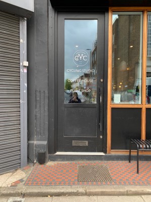 Glass and black wooden door ahead. Push from handle on right to open.