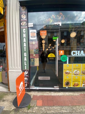 Glass door with silver handle on right. Push to open.