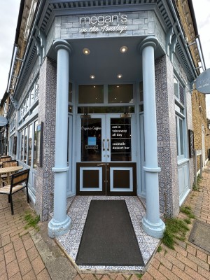 Glass and light blue doors. Gold handles towards top centre of doors. Pull to open. Columns on left and right.
