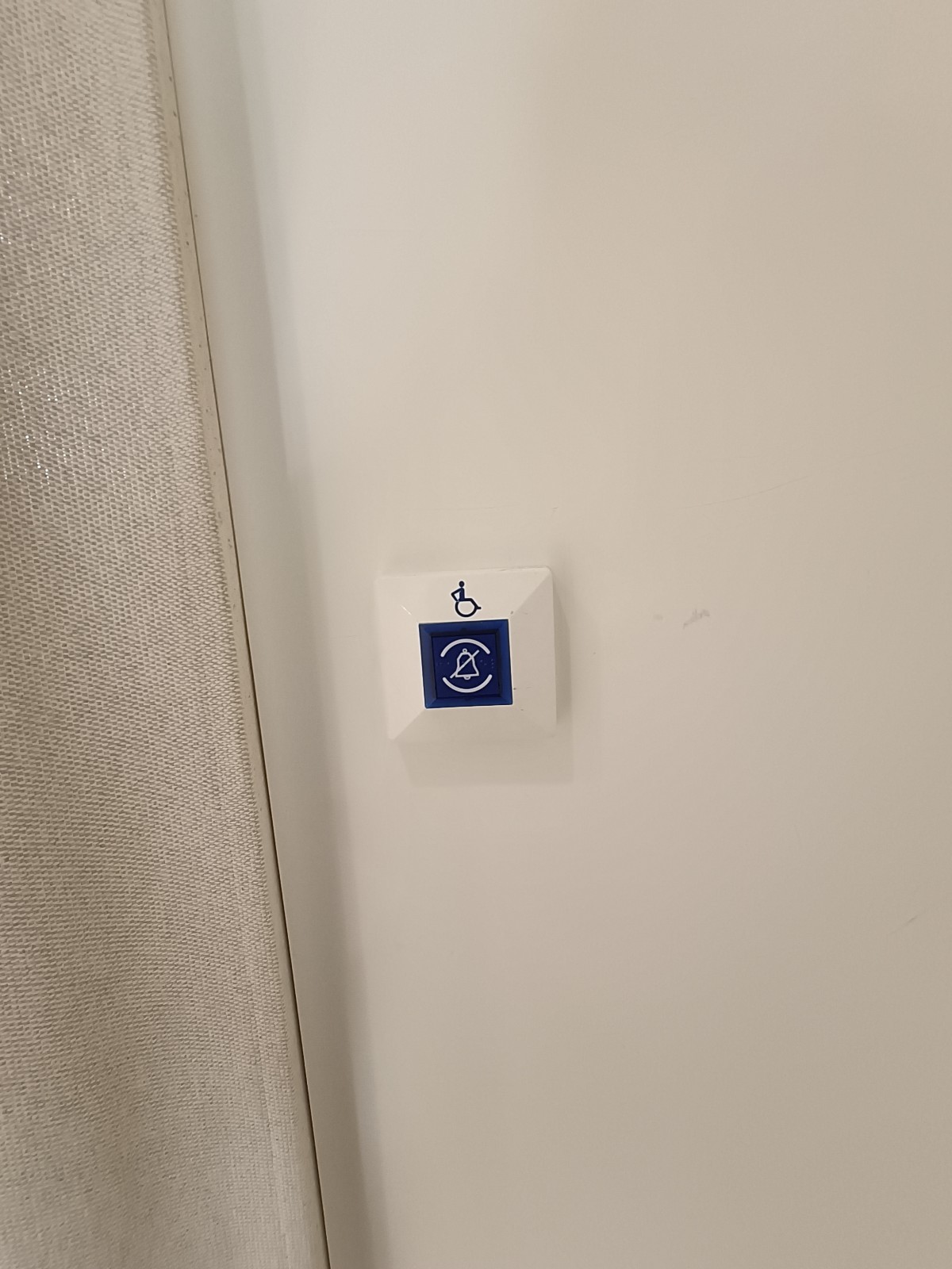 Emergency call button on left fitting room door.