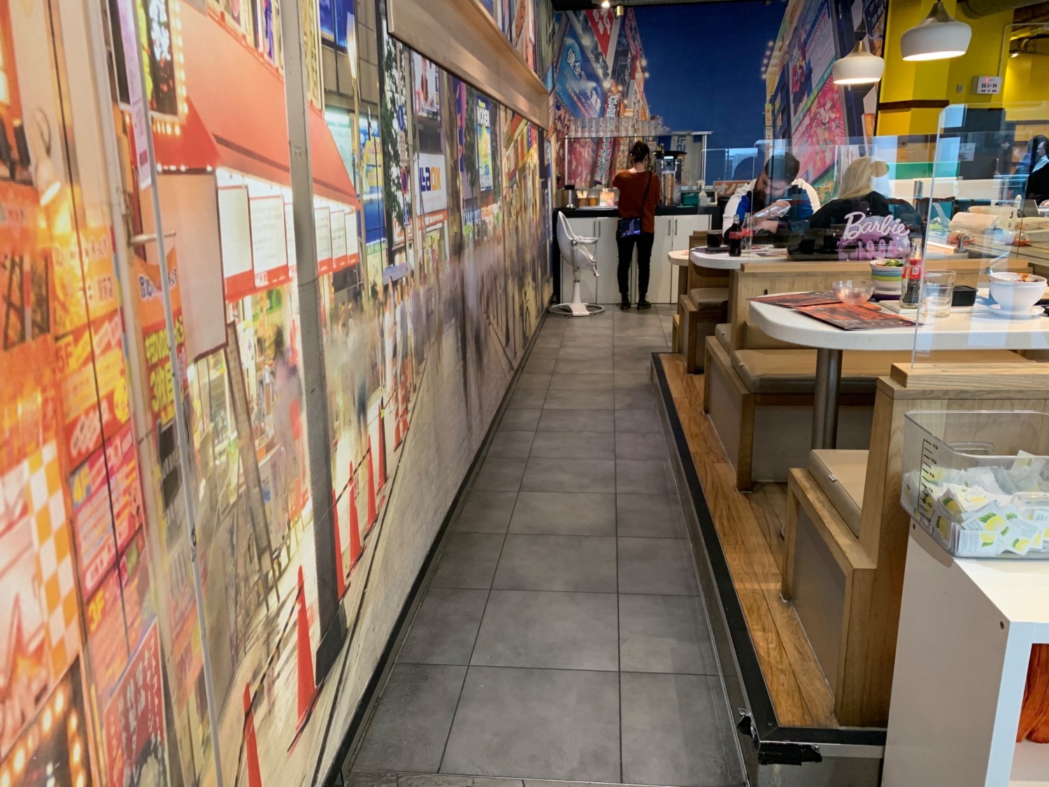 From staff counter facing right. Booths along right. Pathway down centre to further seating.