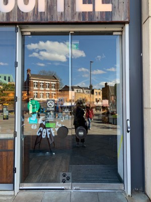 Glass double doors ahead. Push from handles in centre to open.