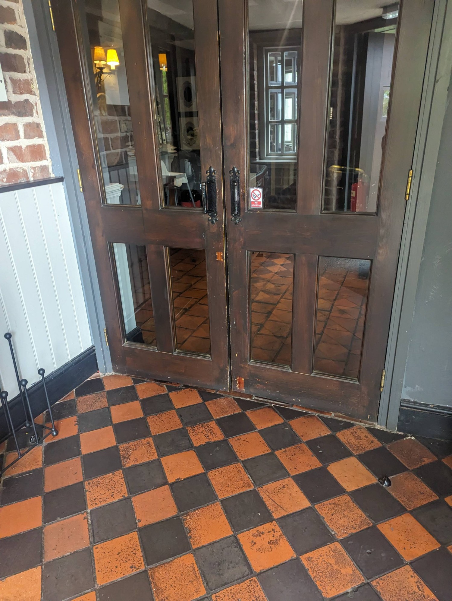 Interior entrance door after the exterior entrance doors. They re wide and fully open however are not automated. They have handles and open outwards.