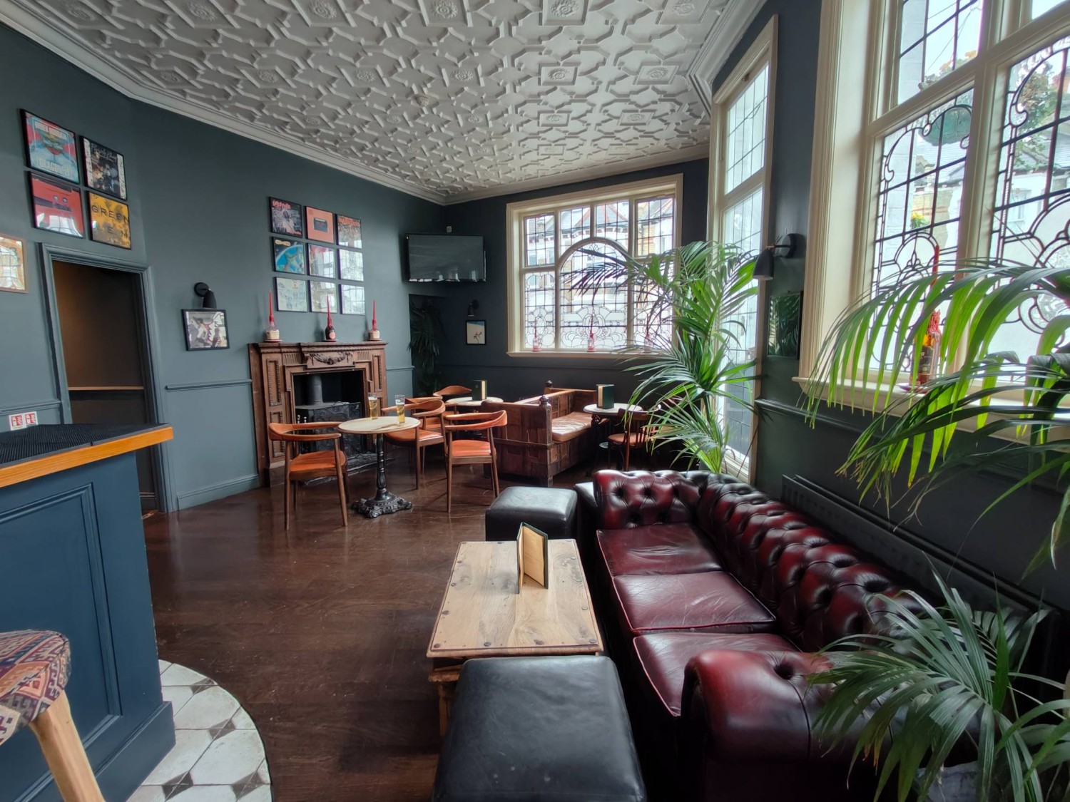 From entrance facing right. Couch seating on right. Half booths along back right wall. Table and chairs on back left.