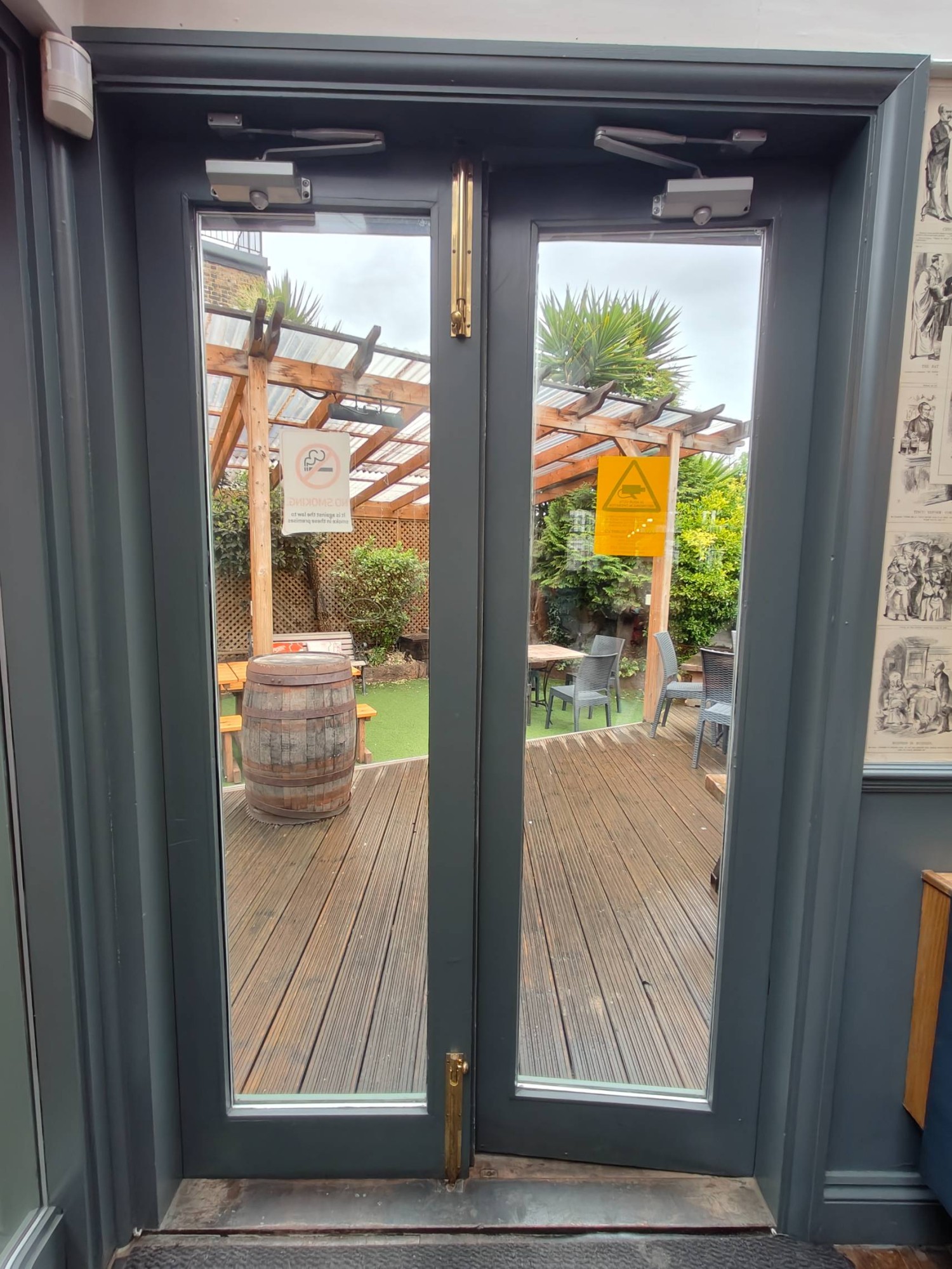 From left end of side area looking straight. Grey framed double glass doors leading to side area. Push in centre to open.