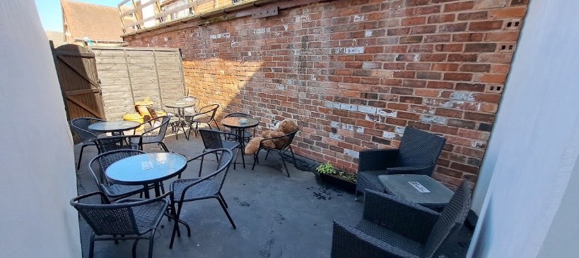 the outdoor seating area with tables and chairs neatly laid out