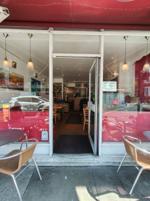 White framed glass door. Push handle on left to open.